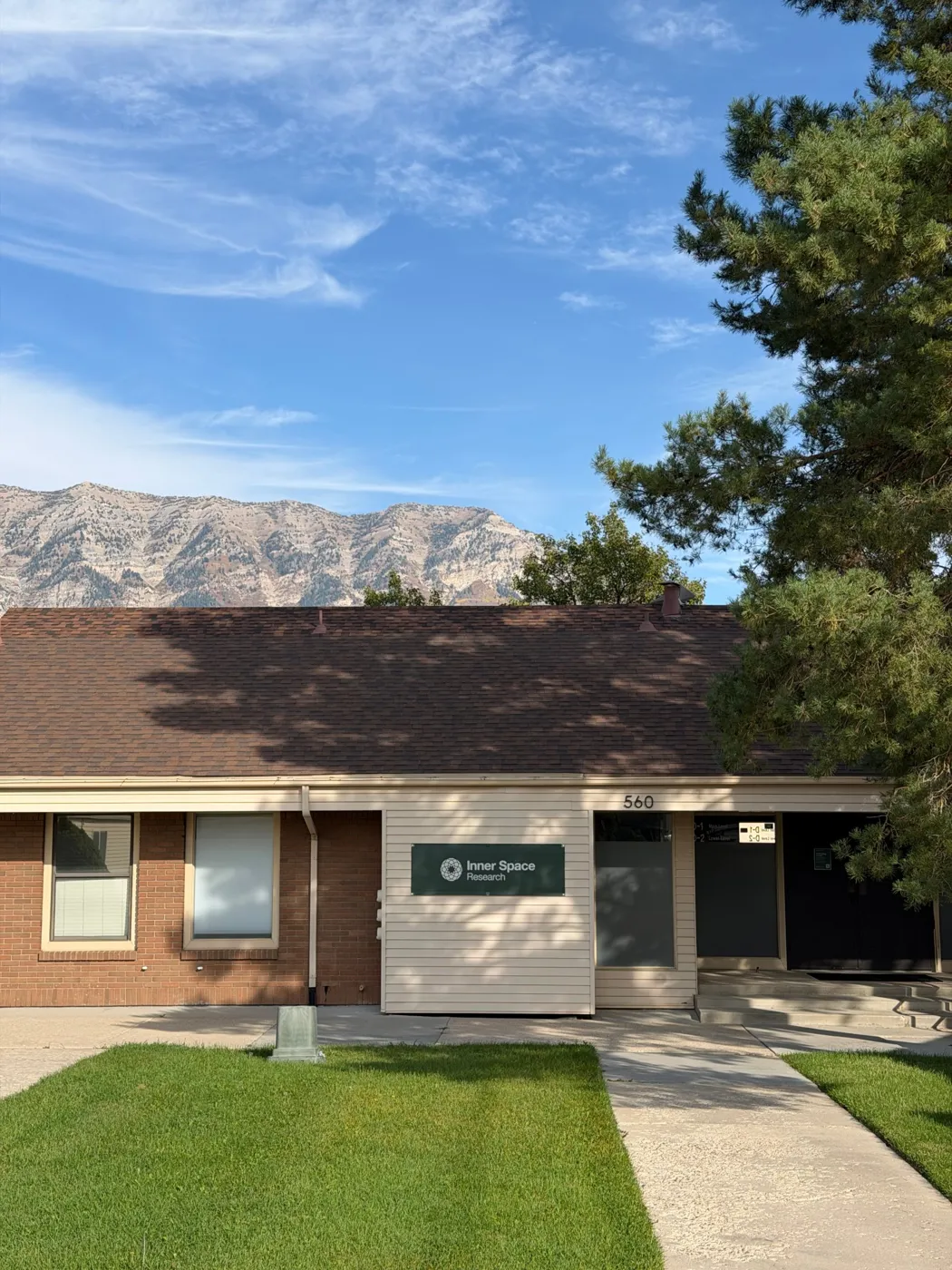 The Inner Space Research building in Orem on a sunny day, with the mountains behind it