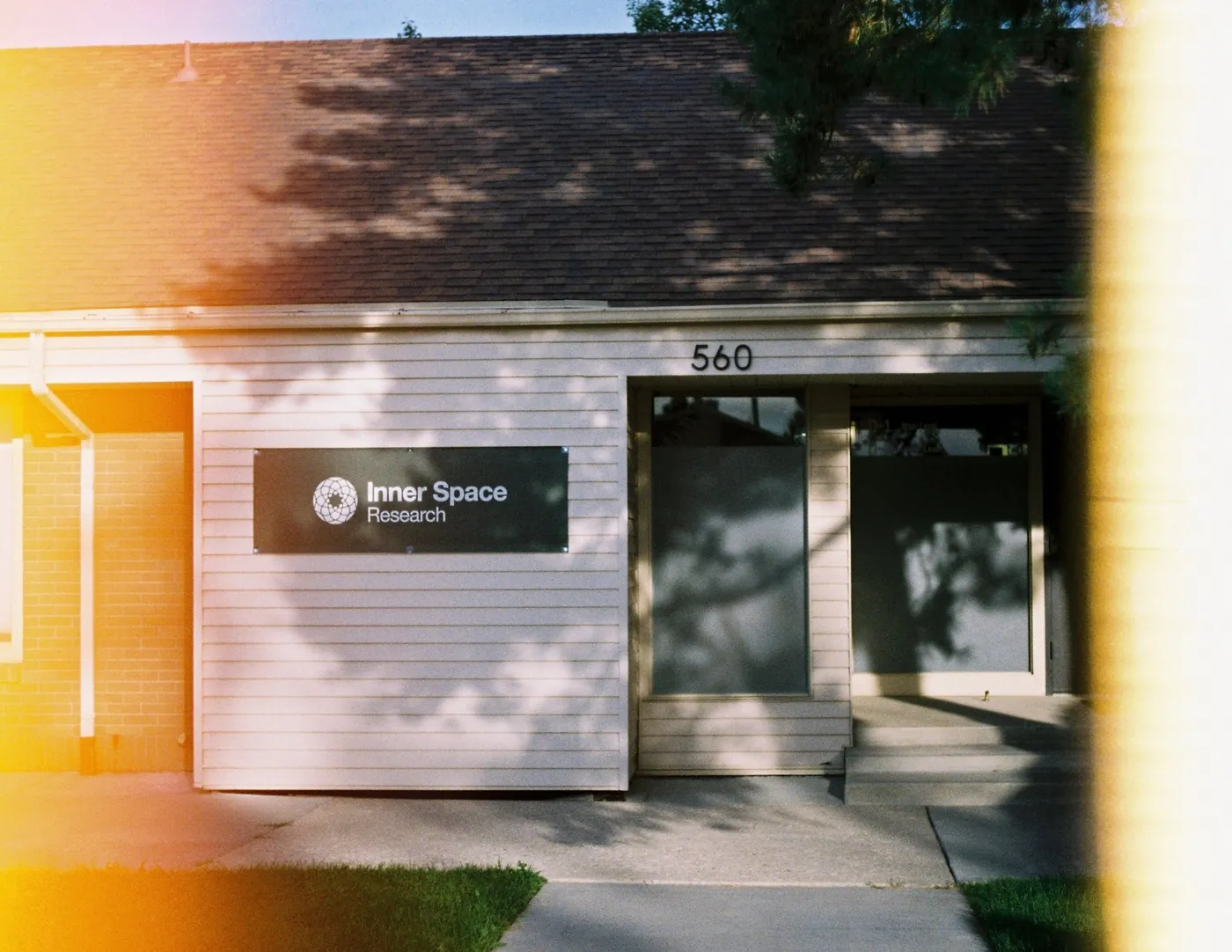 The Inner Space Research building in Orem, with the green sign on the siding